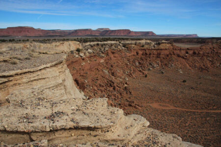 Easterly sweep of the Shinarump, or Chocolate Cliffs. Vermilion Cliffs, and White Cliffs in background. All are part of John Wesley Powell's Grand Staircase. Photo courtesy of John W. Hiscock, Arizona